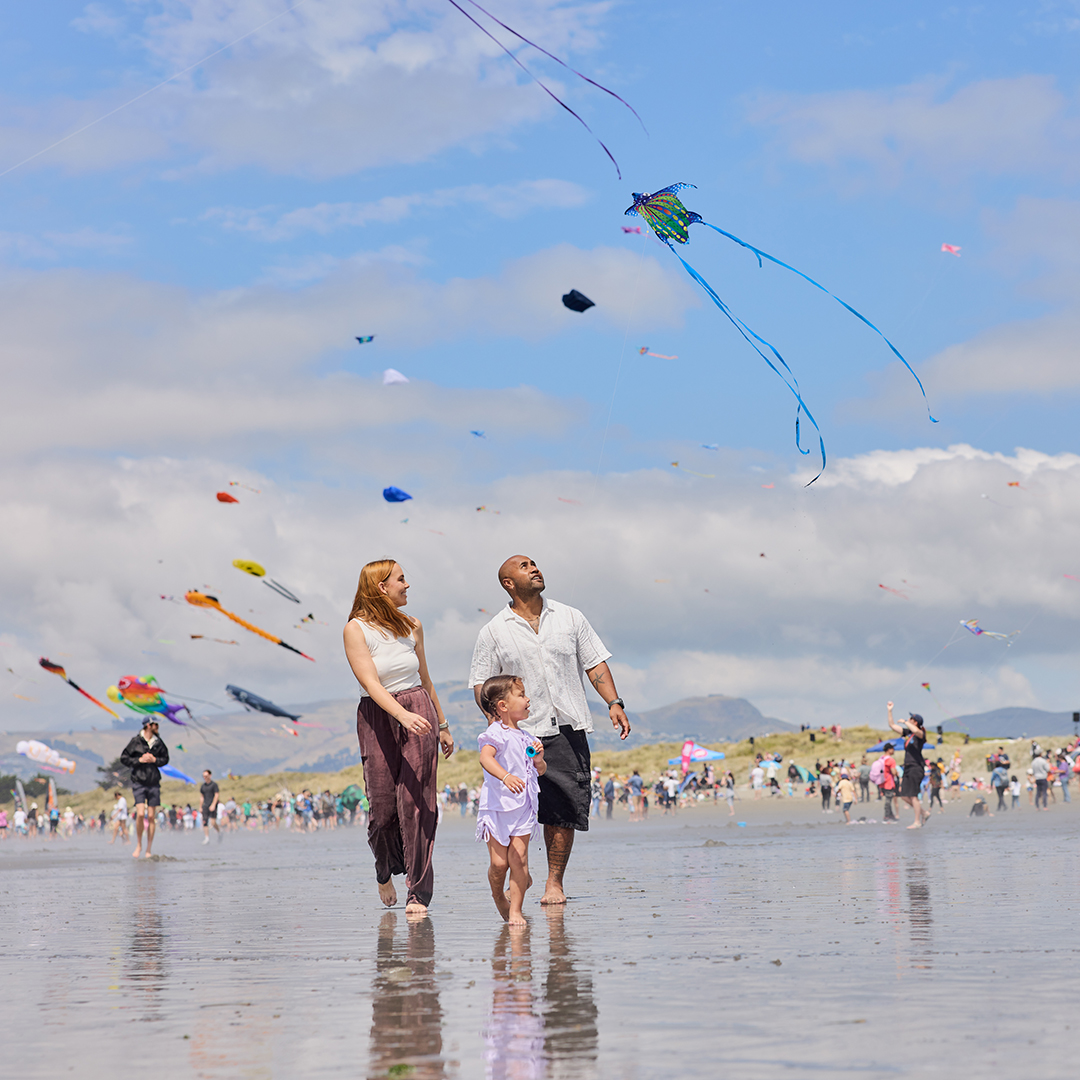 Family walking on the beach during Kite Day