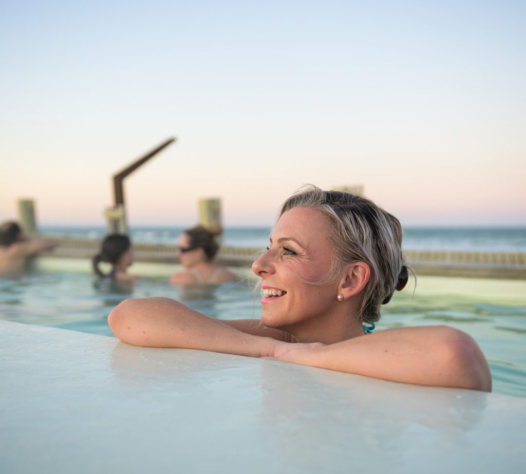 A woman relaxing ain a hot pool at He puna Taimoana